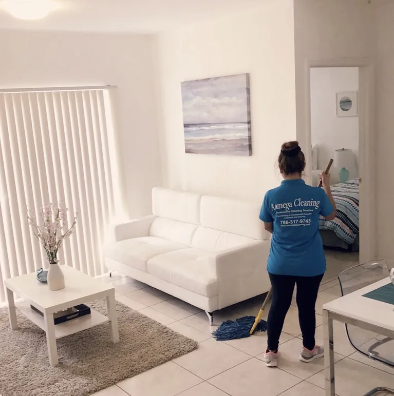 A cleaner cleaning a livingroom with a mop in miami