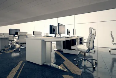 a picture of a big office with plenty desks and computers.